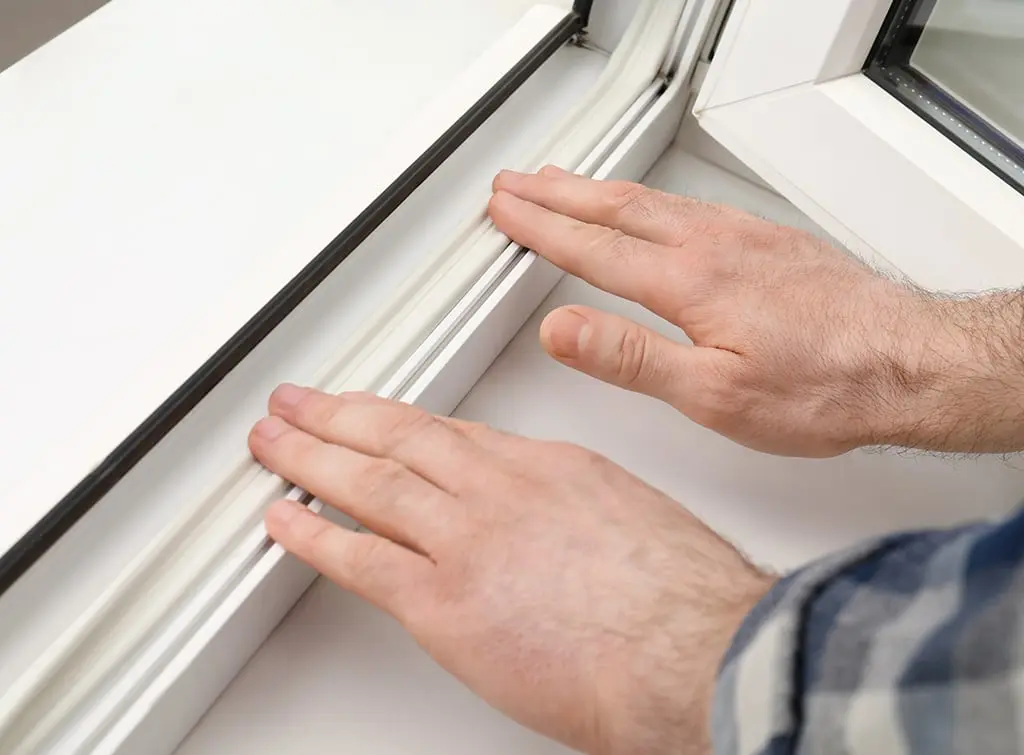 Applying weatherstripping to stop draughty windows