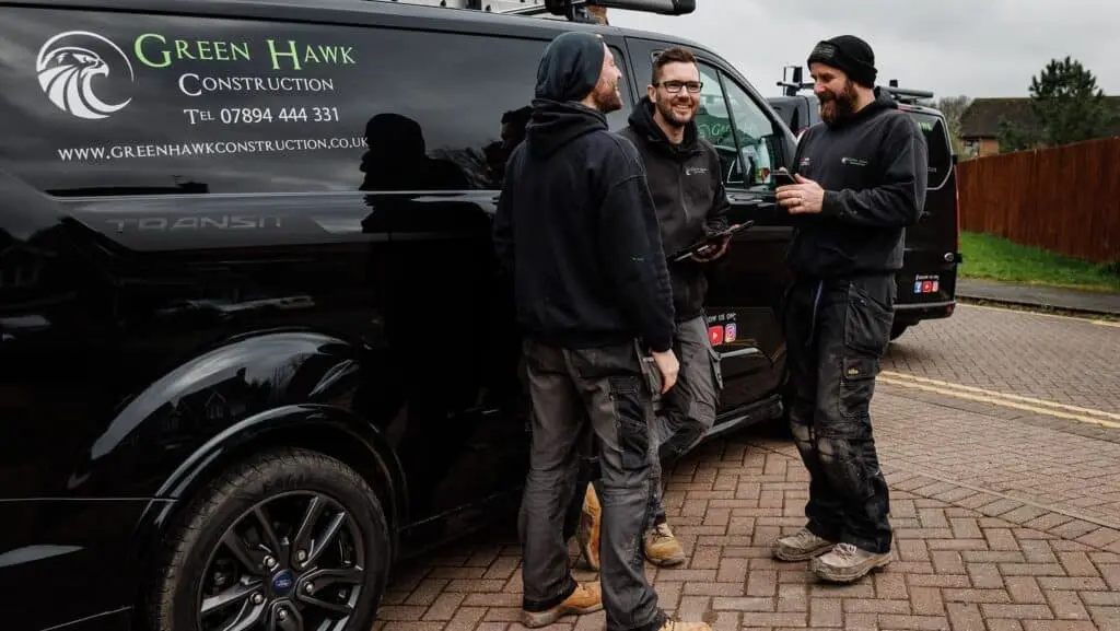 https://www.checkatrade.com/blog/wp-content/uploads/2024/02/green-hawk-construction-mike-shaun-and-steve-1024x577.jpg