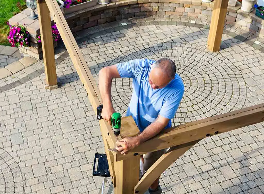 Aerial view of a tradesperson building a pergola
