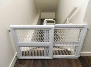 Baby gate at top of steep staircase