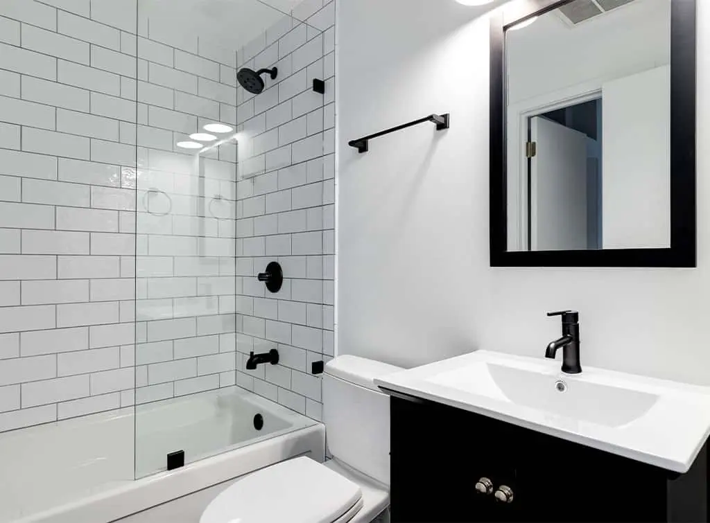 Small bathroom with shower over bath