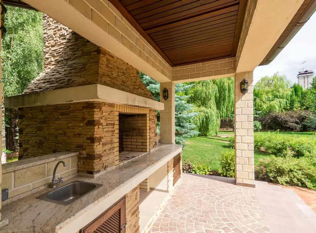 Outdoor stone kitchen patio fireplace