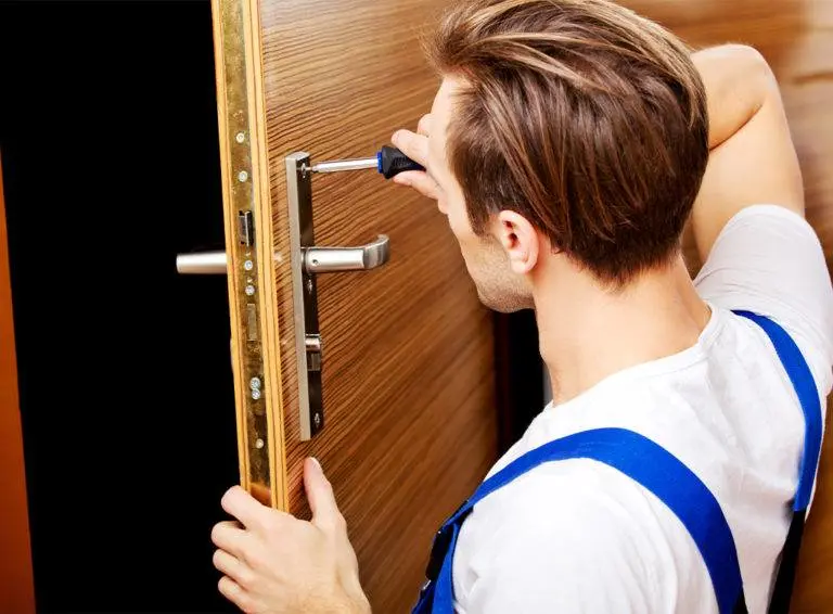 Locksmith replacing door lock