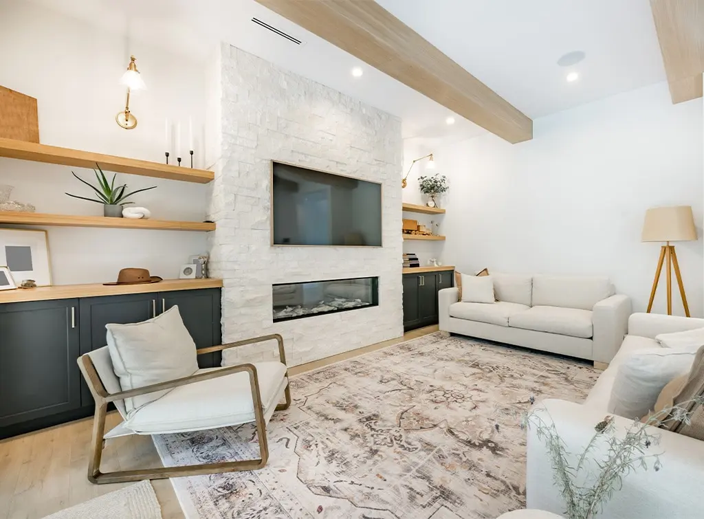 Floating shelves and built-in cabinetry in living room alcoves