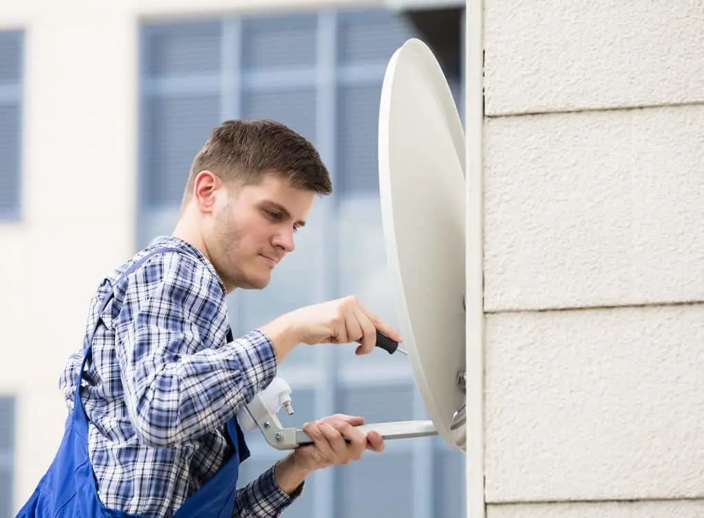 Man repairing satellite dish