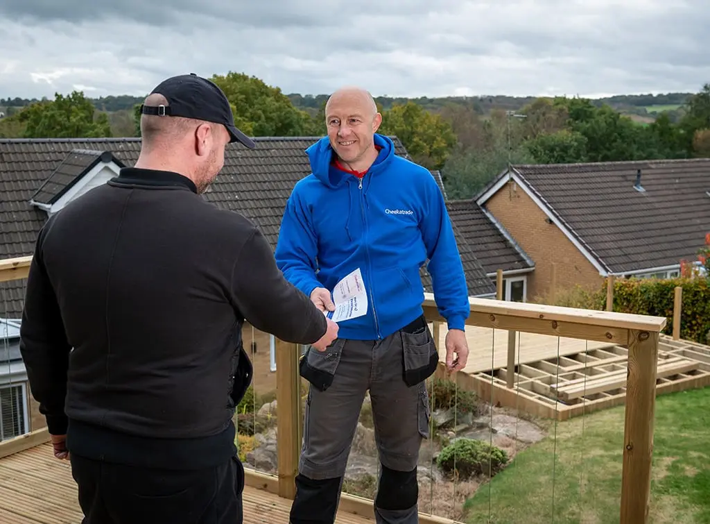 https://www.checkatrade.com/blog/wp-content/uploads/2022/04/Checkatrade-member-with-guaranteed-work.jpg