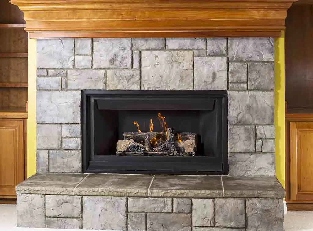 A fireplace with a wooden mantel can be painted over for a new look - Cheap fireplace makeover with a painted mantel