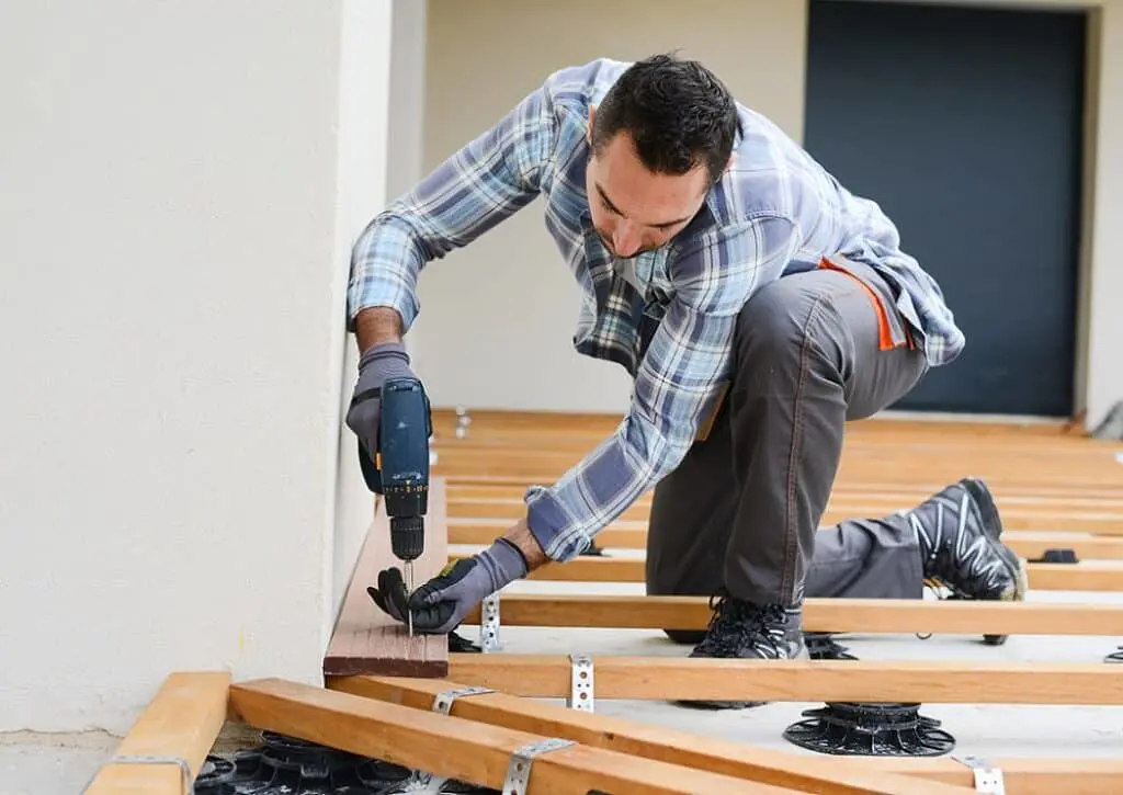 https://www.checkatrade.com/blog/wp-content/uploads/2024/06/carpenter-installing-wooden-flooring-1024x725.jpeg