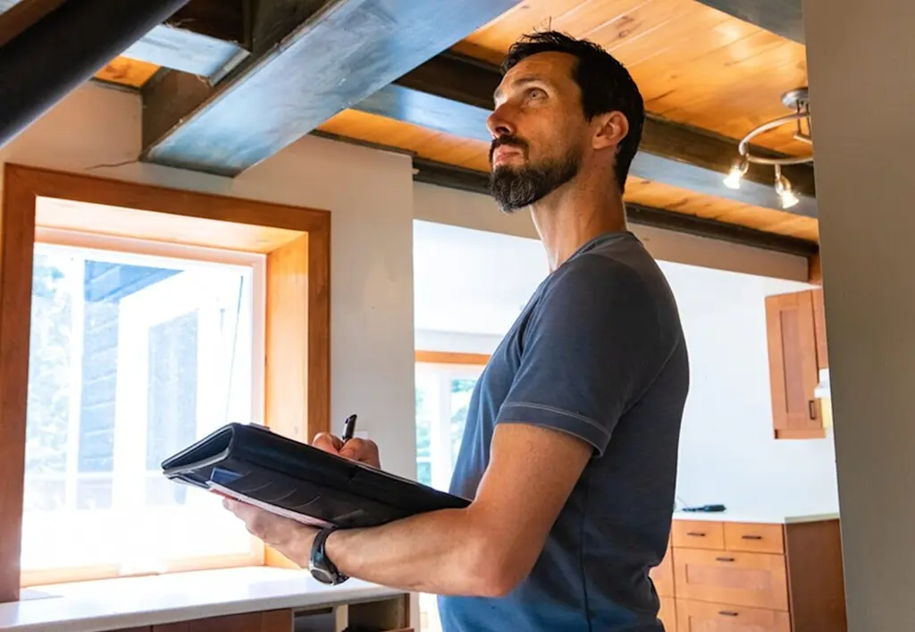 Tradesperson doing home survey
