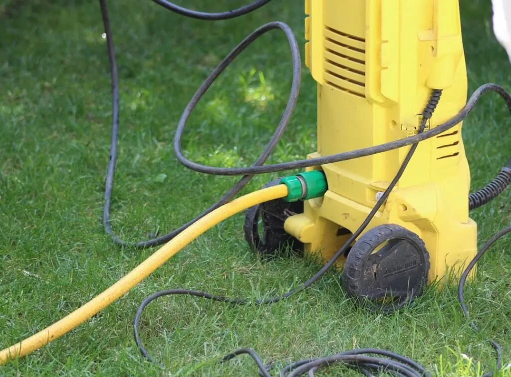 https://www.checkatrade.com/blog/wp-content/uploads/2024/09/pressure-washer-ready-to-clean-bin-1.jpeg