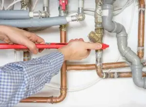 engineer fixing boiler pipes
