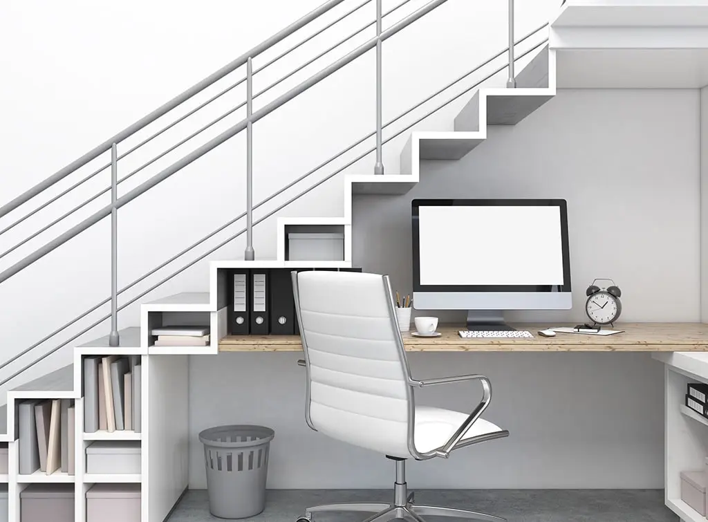 Grey painted metal staircase with under-stair home office