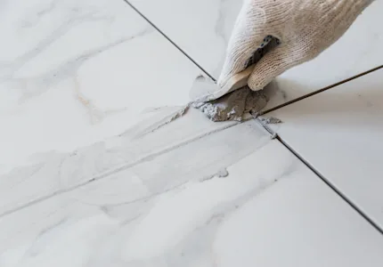 Grout application on tiled floor