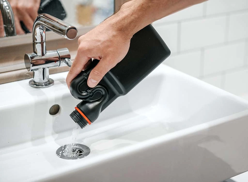 Unblocking product being poured into sink