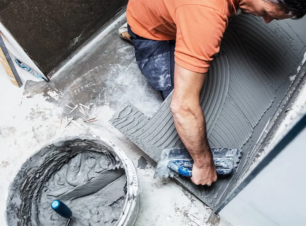 Wet room installer laying the floor
