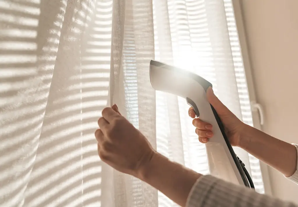 Steam cleaning a curtain