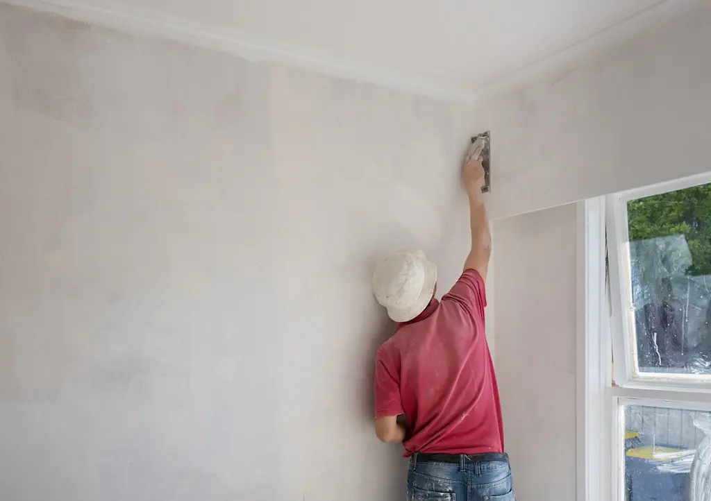 Plasterer skimming a wall