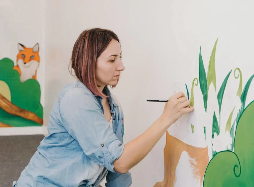 woman painting a child