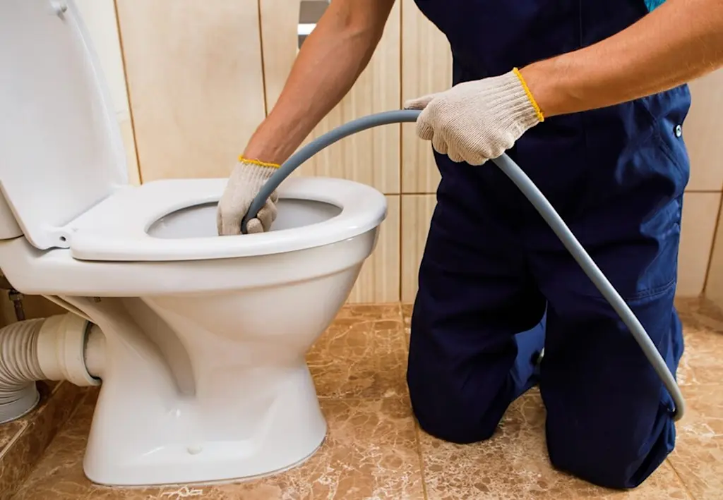 Rodding a blocked toilet