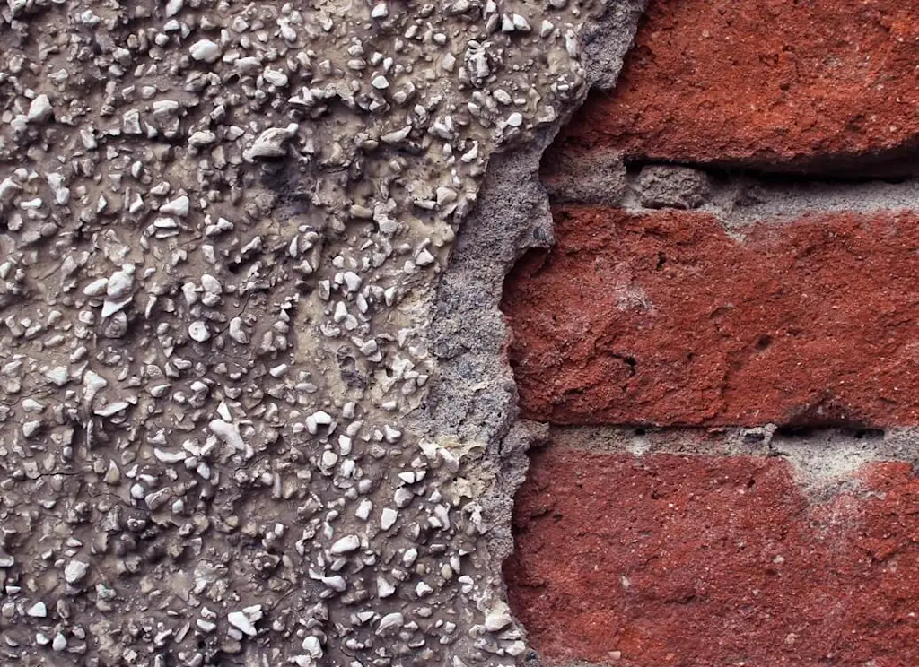 Pebble dash coming away from brick