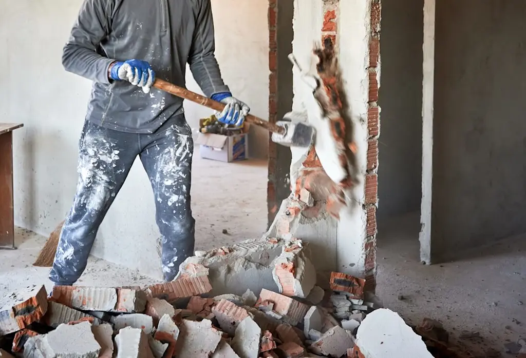 Tradesperson carrying out demolition