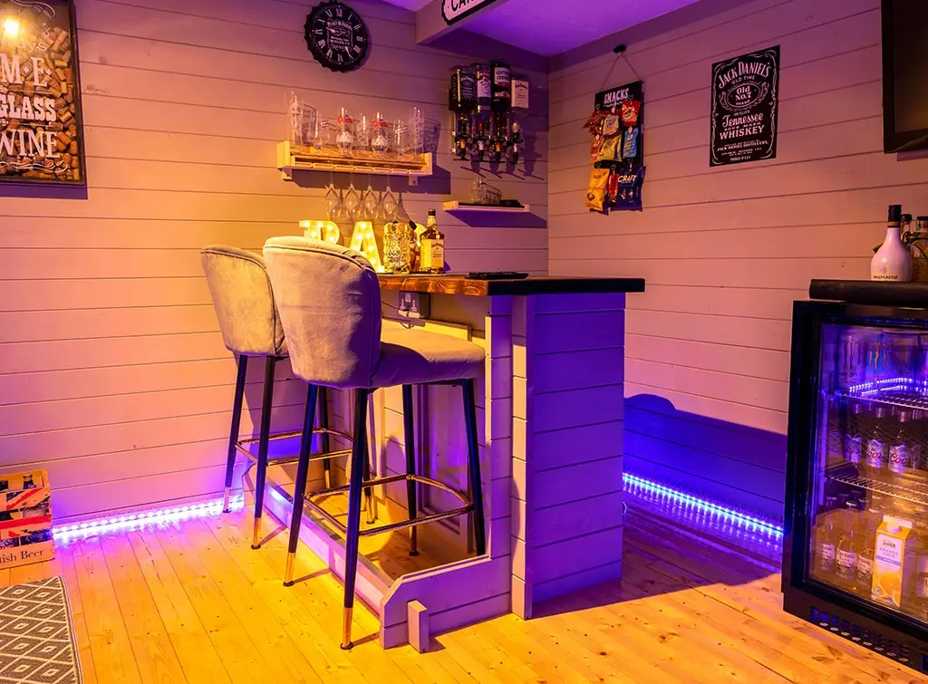 Bar with neon lights in a she shed for interior ideas