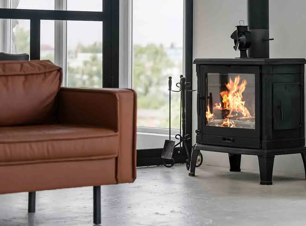 A cast iron fireplace next to a brown sofa - restore your cast iron fireplace for an easy makeover