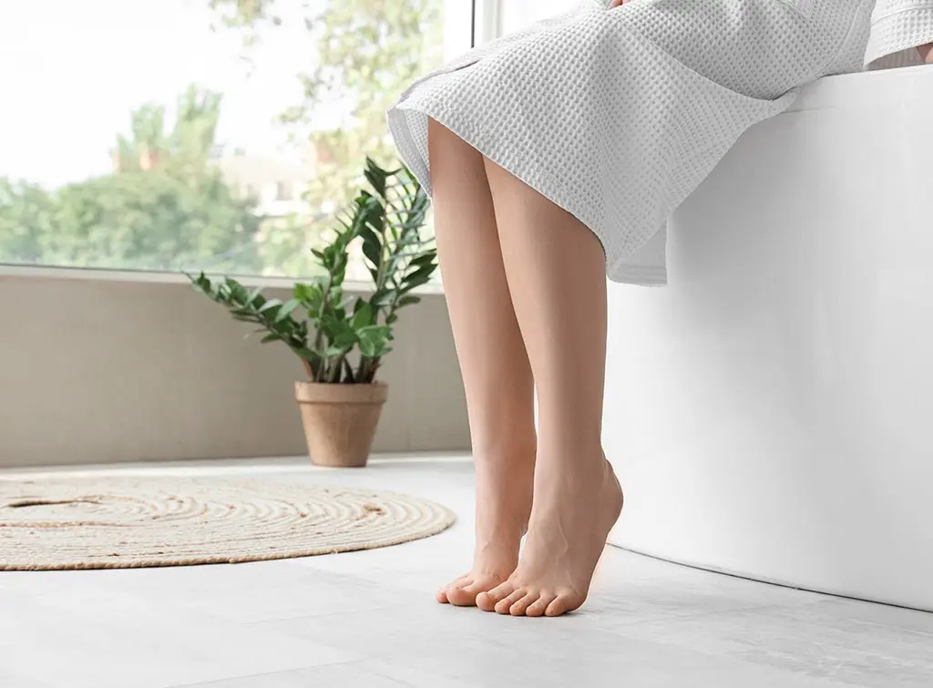 Bare feet on bathroom underfloor heating