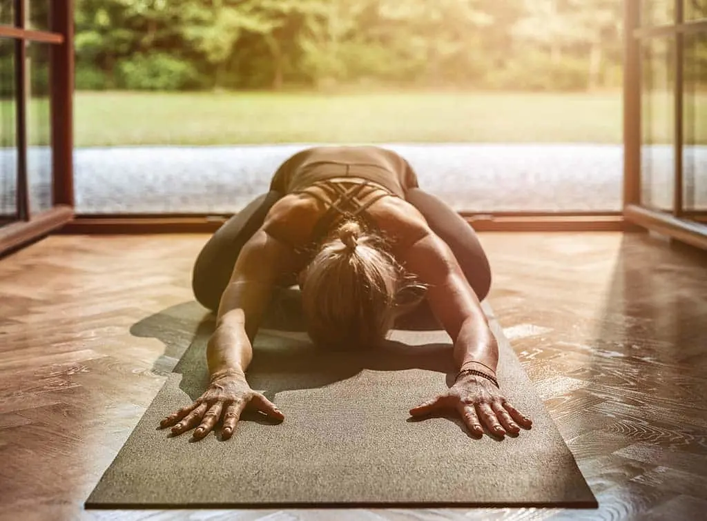 Woman doing yoga in her garden room