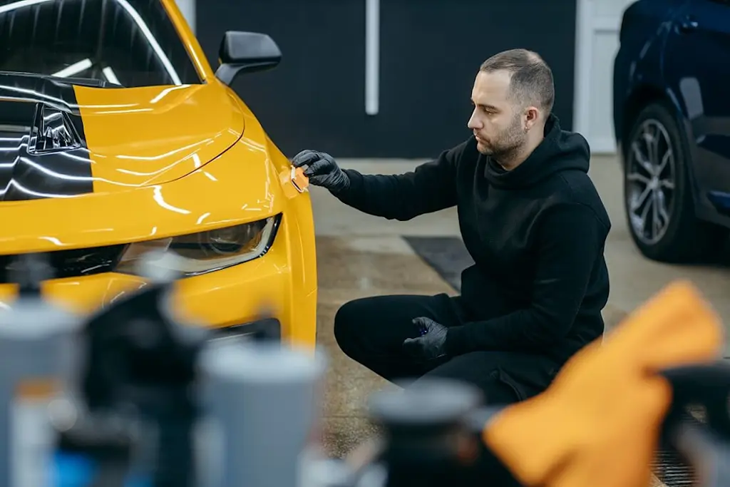 tradesperson detailing on car