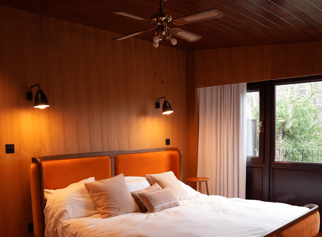 Large windows in this midcentury modern bedroom encourage a connection with the outdoors