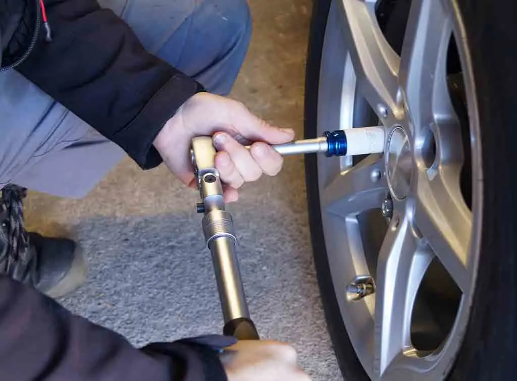 https://www.checkatrade.com/blog/wp-content/uploads/2022/03/mechanic-removing-locking-wheel-nut.jpg