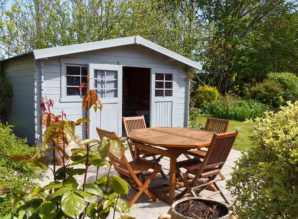 Beautiful grey shed in sunny garden