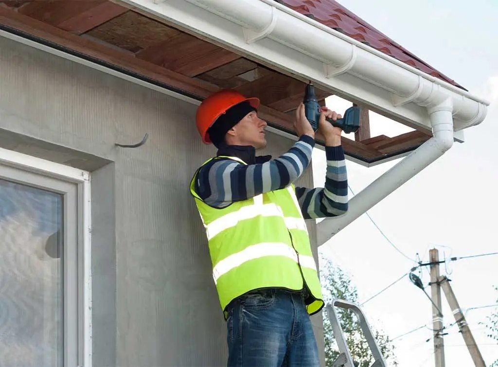 Roofer replacing soffits