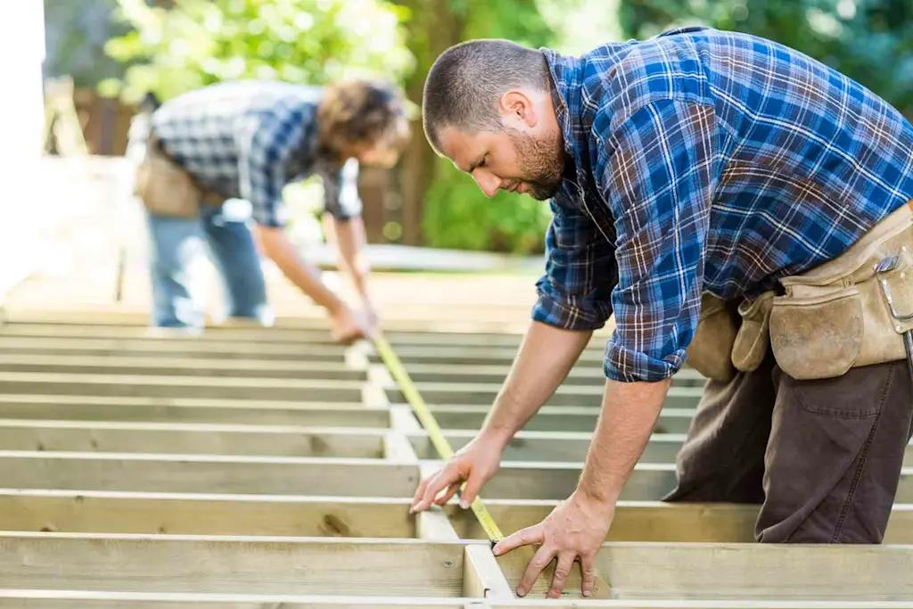 Tradespeople installing decking