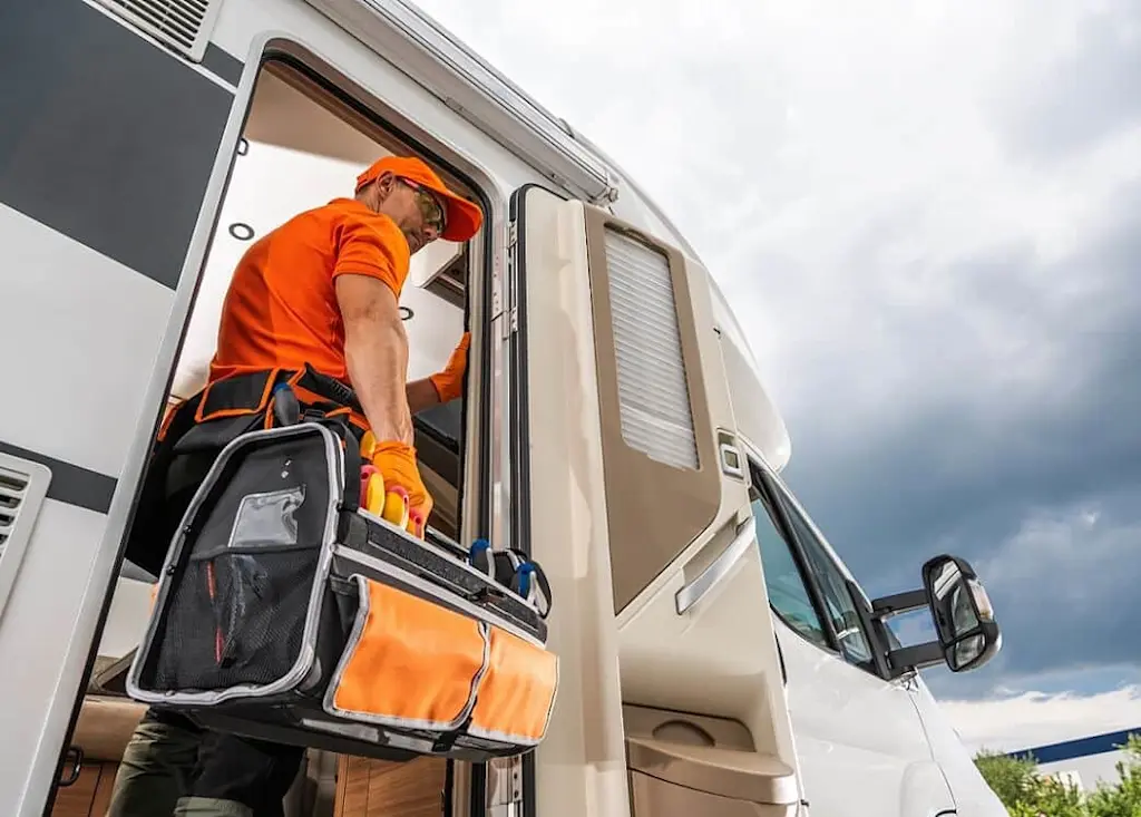 tradesperson-carrying-out-caravan-maintenance
