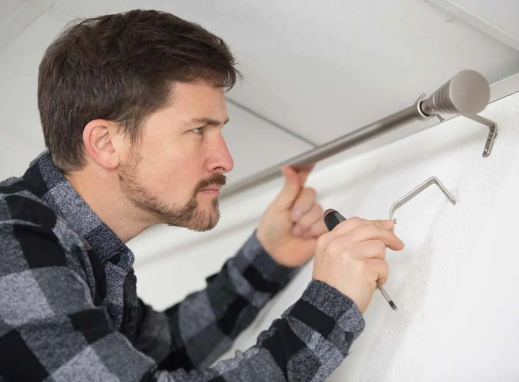 https://www.checkatrade.com/blog/wp-content/uploads/2022/03/Curtains-Hanging-1-1.jpg