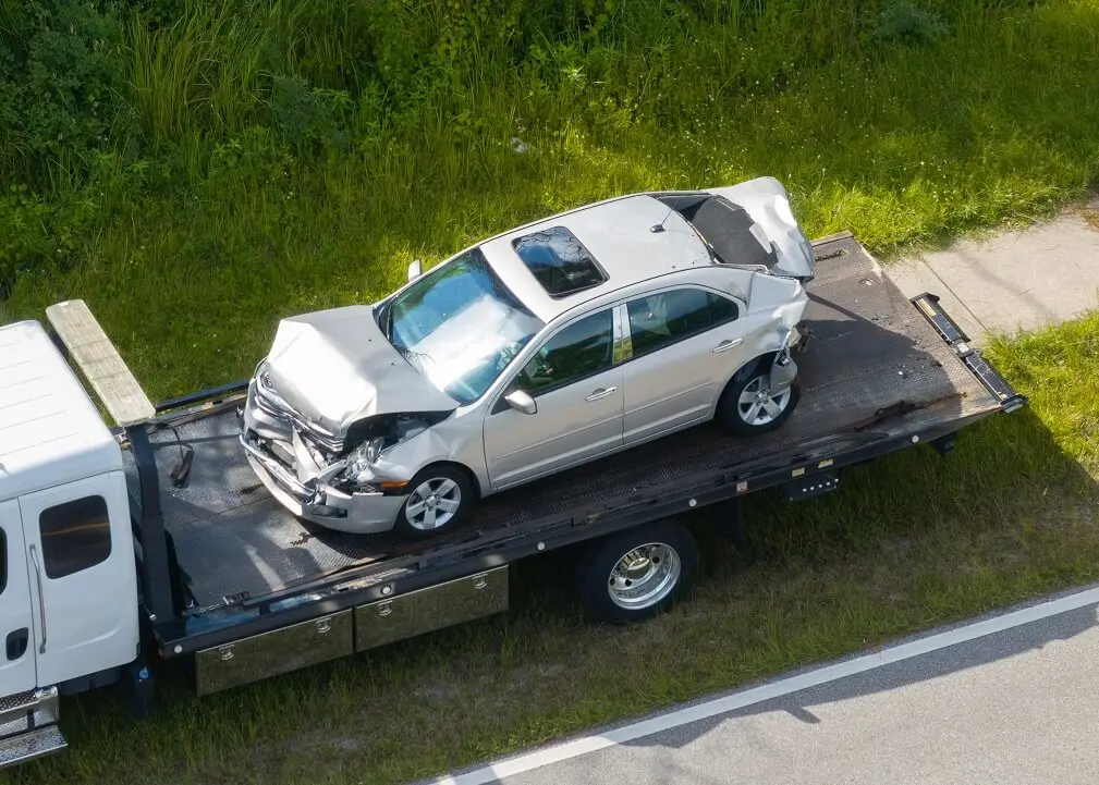 removing wrecked car for scrap