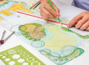 Garden designer planning a garden layout - garden designer cost