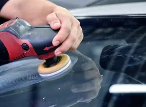 Professional removing scratch from car window