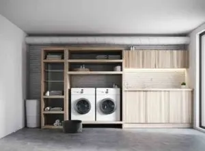 A washer/dryer set in a wooden shelving unit - utility room remodel cost