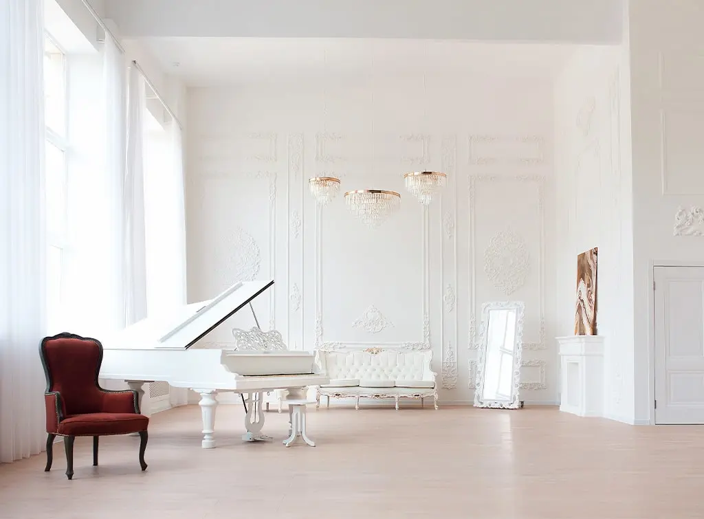 an all white piano room