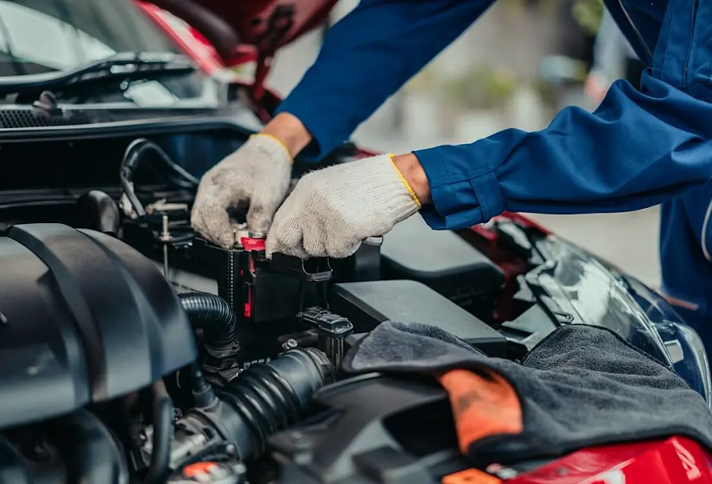 mechanic inspecting car engine