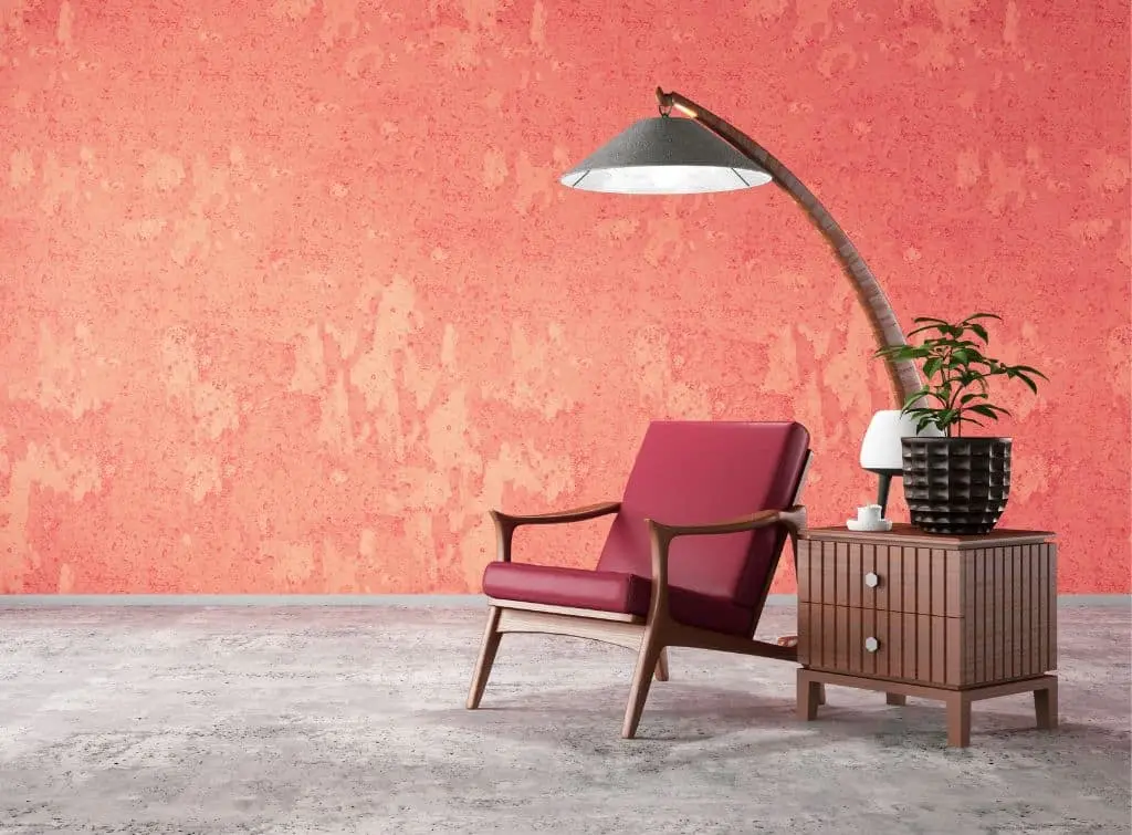 Distressed red walls with concrete style floors in a minimalist room