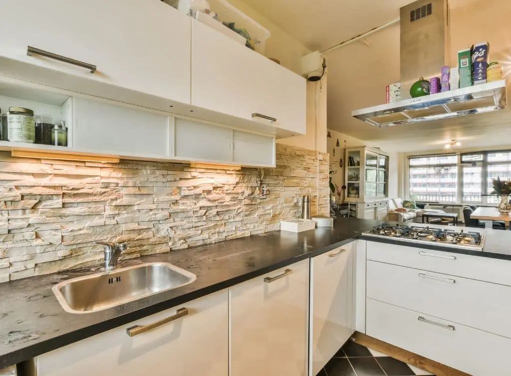 https://www.checkatrade.com/blog/wp-content/uploads/2023/10/Small-galley-kitchen-with-raw-brick-splash-back.jpg