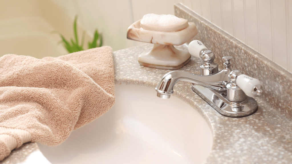 Bathroom sink with a subtle terrazo splashback and units