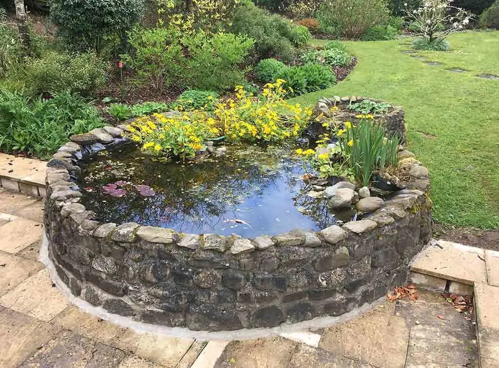 https://www.checkatrade.com/blog/wp-content/uploads/2021/04/Raised-stone-pond-design-2.jpg
