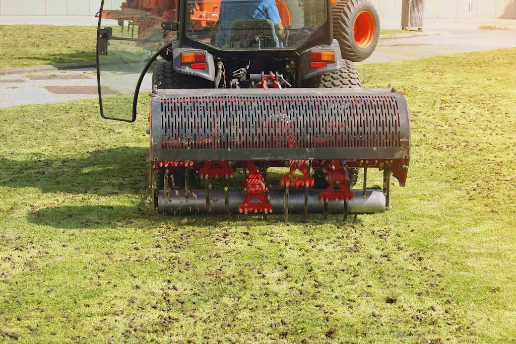 Lawn aeration to avoid soil compaction as part of winter lawn maintenance