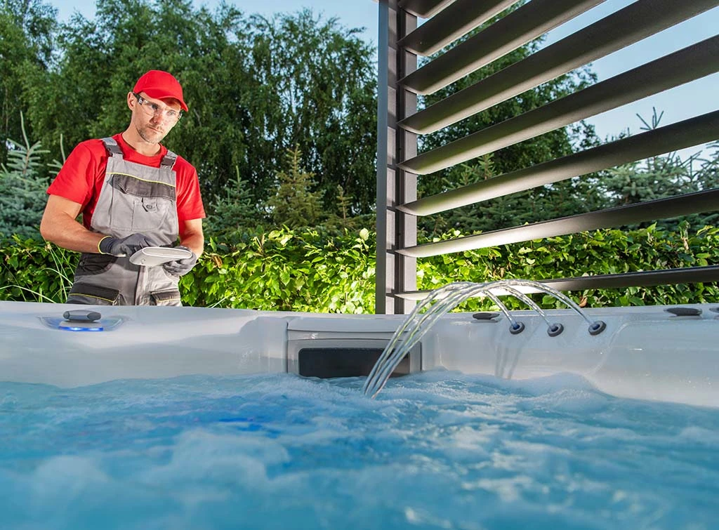 https://www.checkatrade.com/blog/wp-content/uploads/2021/12/hot-tub-installation-tradesperson.jpg