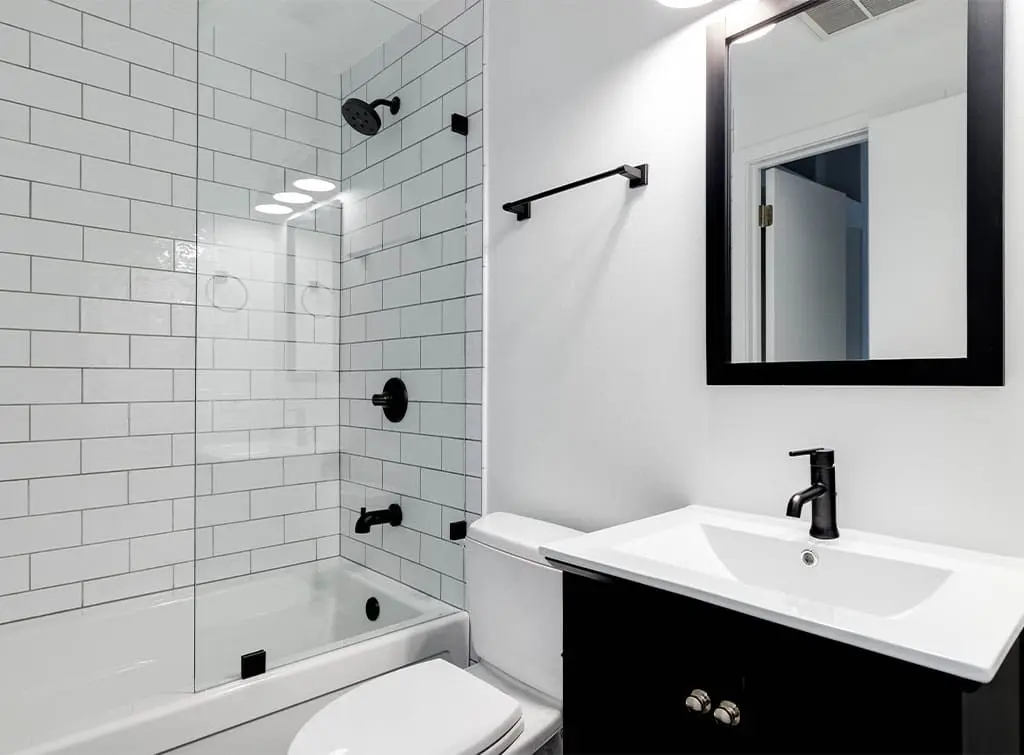 Concealed valve shower in a black and white bathroom
